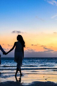 Couple holding hands on the beach