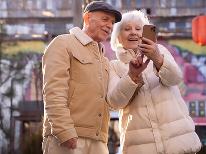 Senior individuals capturing a selfie, reflecting longevity and the passage of time