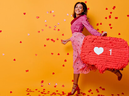 A woman confidently showcasing a thumbs-up decoration, exuding enthusiasm and approval
