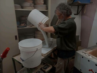 Joan Crous pouring materials in a container