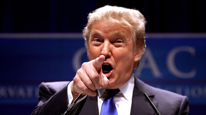 Former President Donald Trump pointing at a the crowd at a press conference