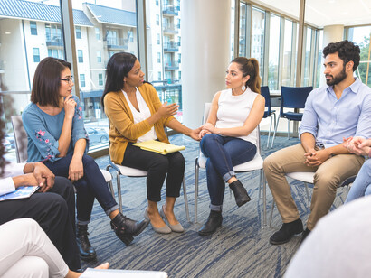 Community members gathering in a dialogue circle to share experiences and perspectives