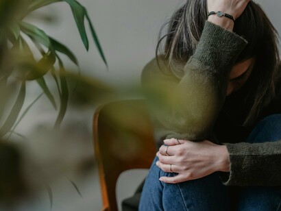 Mulher em sofrimento. A doença geralmente se manifesta entre os 30 e 60 anos, mas pode ocorrer em qualquer idade. Ter um histórico familiar também pode aumentar as chances de desenvolver a condição, sugerindo um componente genético envolvido