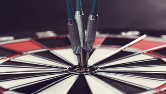 Darts hitting the bullseye, symbolizing success
