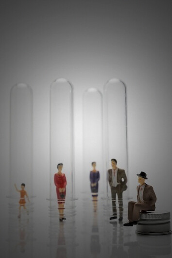 People enclosed in glass tubes, exploring themes of social identity and cultural diversity