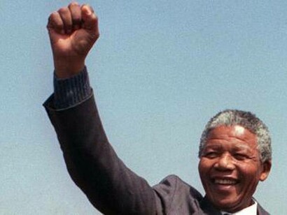 Nelson Mandela raises a fist in the air in Port Elizabeth on April 1, 1990