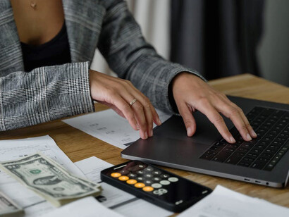 On the table, you'll find an array of items: papers, a calculator, coins, and various investment instruments