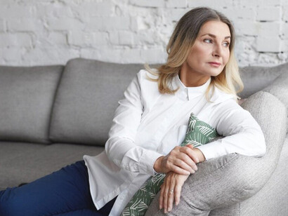 An expressive middle-aged woman looking stressed, symbolizing hormonal transition and perimenopause in women