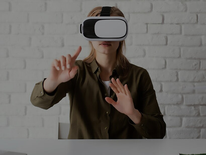 A woman enhances productivity at work by skillfully utilizing VR glasses, showcasing the seamless integration of technology into professional settings