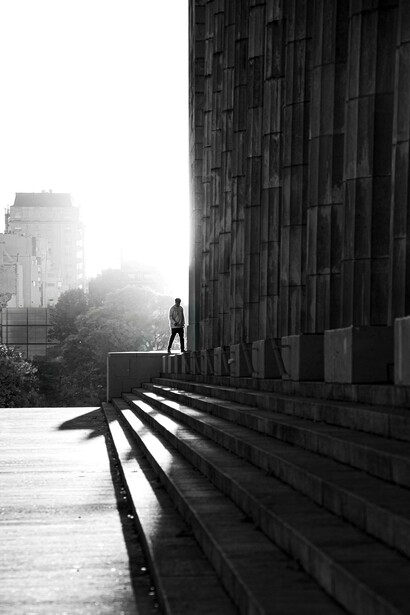 A staircase and figure showcasing how each step of civilization shapes who we are and our beliefs 
