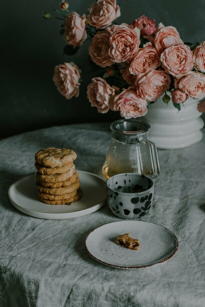 A mug of coffee and a stack of cookies on a table 