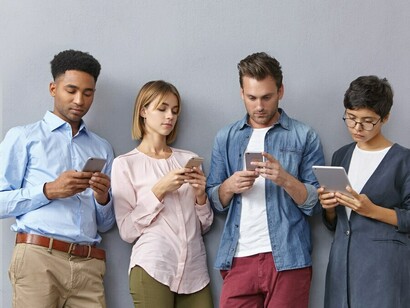 Overwhelmed and absorbed in their screens, a group of individuals reflects the impact of constant connectivity on daily life