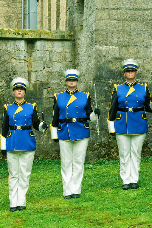 A marching band prepares to fill the streets of Kerkrade, Netherlands, with vibrant melodies, celebrating the unique cultural blend of the Netherlands, Belgium, and Germany at the border's heart