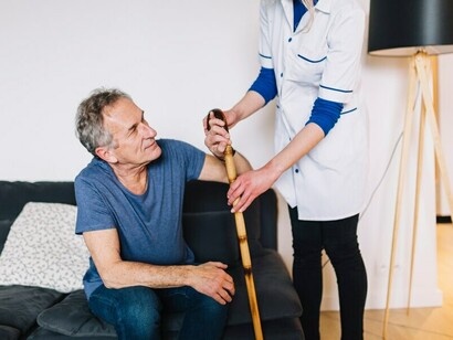 A man recovering from a stroke with a nurse in a retirement home