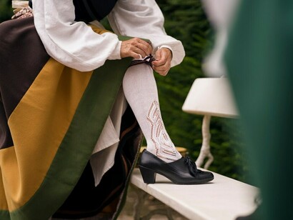 A woman wearing traditional folklore dress celebrates cultural heritage preservation, embodying cultural identity, diversity, and the spirit of traditional festivals