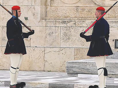 In Syntagma Square, Athens, Greece, the Evzones carry out a meticulous and ceremonial Changing of the Guard at the Tomb of the Unknown Soldier, showcasing their precision and dedication