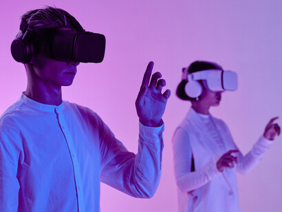 A man and a woman interacting with their VR headsets 