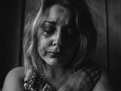 A woman in tears is trying to cope and get through a lost love
