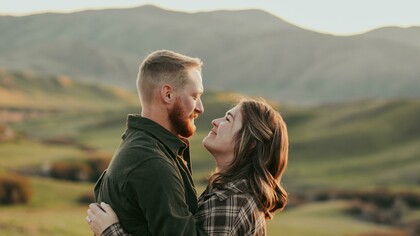 A couple embracing while gazing into each other’s eyes
