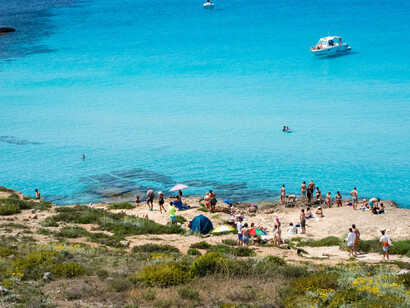 A scenic coastal view of Sicily's crystal-clear blue waters, capturing the beauty of the Italian seaside