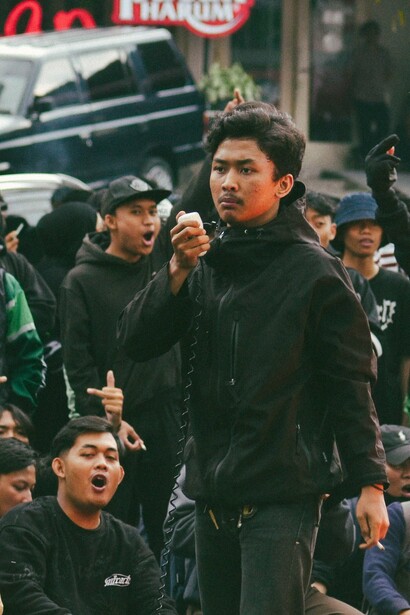 A young protester addressing a crowd in Bandung, Indonesia, symbolising the spirit of resistance and solidarity that was seen during the Bandung Conference