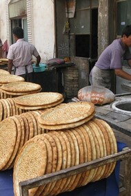 Panettieri di strada che sfornano naan nel cuore di Kashgar, Cina. Foto di Giò Barbieri