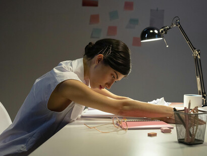 Stressed professional woman working late in the office
