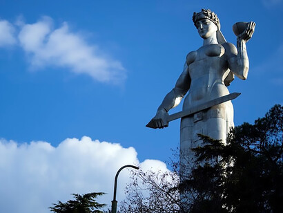 Woman holding sword statue near trees, Kartlis Deda, Tbilisi City, Georgia