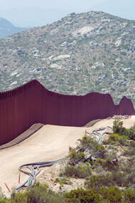 The USA–Mexico border wall in Southern California, cutting through the mountains