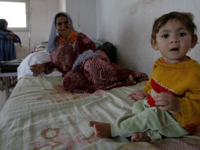 A woman sits on a hospital bed with her daughter, Nada Omer, who is suffering from fever and cerebrospinal inflammation, at a public hospital in Sharqia province, Egypt, 260 km northeast of Cairo, on June 10, 2008