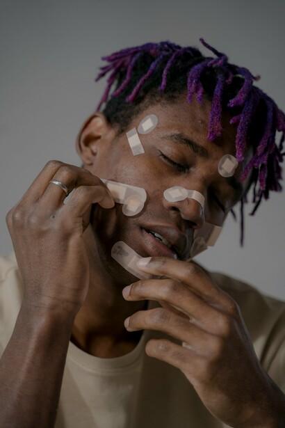 A person with plasters on their face. Flagrant is the validation of what occurred