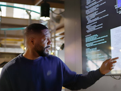 In a dynamic seminar, a man discusses coding techniques, providing valuable insights and resources for aspiring programmers to enhance their skills