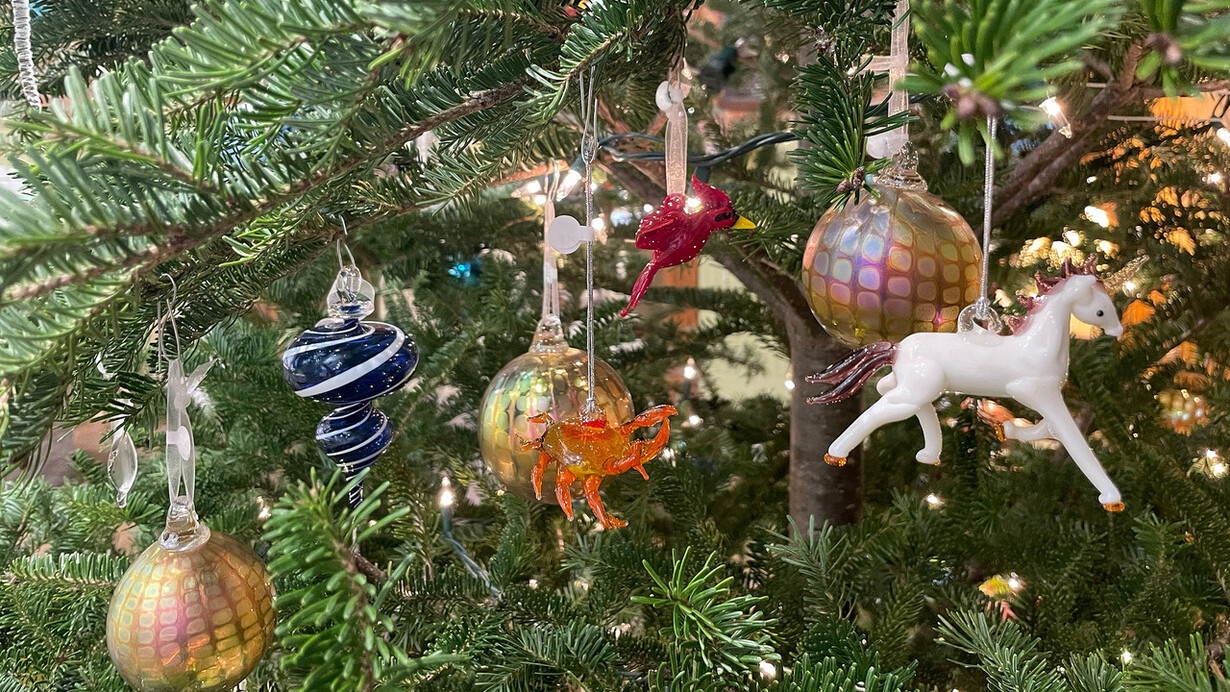 Ornaments hanging off a tree at the gallery in Hudson Beach Glass