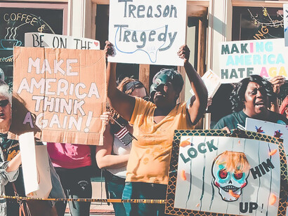 Voters rally outside building, brandishing banner for upcoming US elections