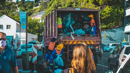 Working class men collect garbage in a wealthy neighbourhood in Cape Town, South Africa