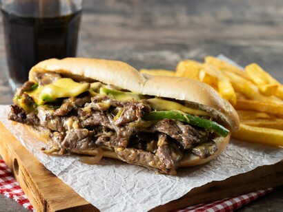 This quintessential Philly cheesesteak, filled with savory steak, melted cheese, and green peppers, is a culinary staple of its namesake city