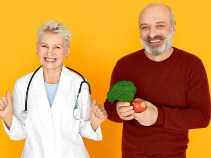 An energetic middle-aged physician with a stethoscope celebrates a positive moment with her smiling senior patien