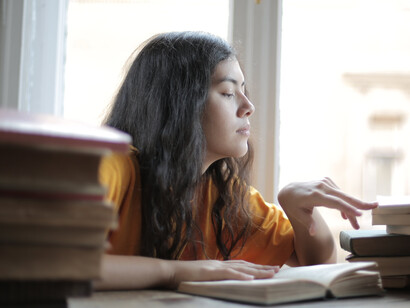 A weary female student experiencing a headache, feeling overwhelmed