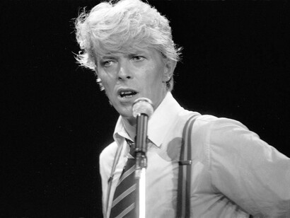 David Bowie channeling the energy of the crowd in a concert in the 1980s