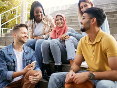 Students are gathered on the stairs, discussing their future goals and aspirations