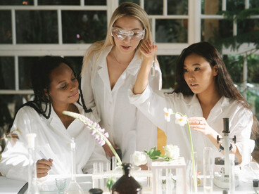 Three researchers examining specimens and conducting experiments in a laboratory, representing humanity's pursuit of scientific discovery 