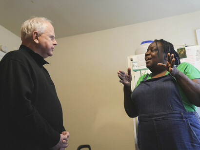Governor Tim Walz talking with a Home Care worker 
