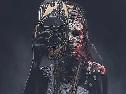 In a detailed close-up, the image reveals a witch from an indigenous African tribe, donned in the vibrant garb of traditional costume