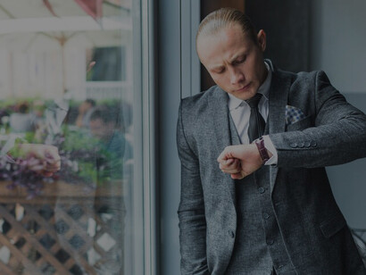 A businessman glancing at his wristwatch, managing time in a fast-paced world