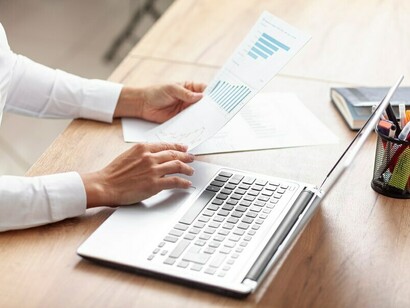 A business professional reviewing papers and contracts as part of the recruitment process, job search, or hiring process, representing the interaction between the employer and potential candidates