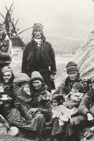Nordic Sámi people in Sápmi (Lapland) gathered in front of two traditional Lavvu tents, showcasing their nomadic lifestyle that has endured for centuries across the vast northern landscapes of Norway and Sweden
