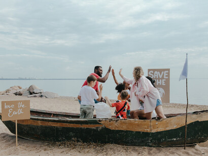 Families at the beach collecting plastic bottles