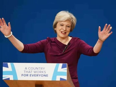 A happy Theresa May delivering her speech in front of the country