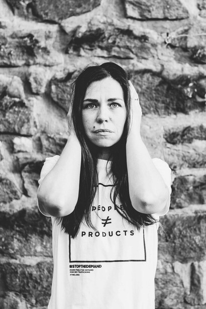 A woman covers her ears so she cannot hear what is going on in the world