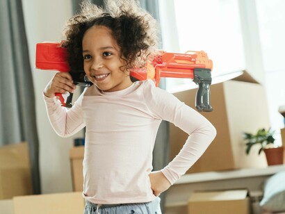 Young girl smiles with a water gun